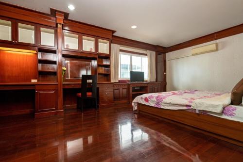 a bedroom with a bed and a desk and a computer at Orchid Pool Villa Phuket - SHA Extra Plus in Phuket Town