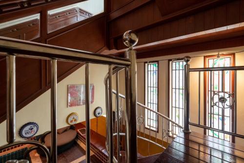a staircase in a house with wooden walls at Orchid Pool Villa Phuket - SHA Extra Plus in Phuket Town