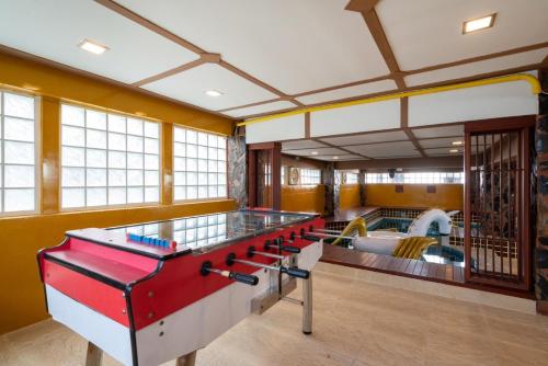 a large room with a ping pong table at Orchid Pool Villa Phuket - SHA Extra Plus in Phuket Town