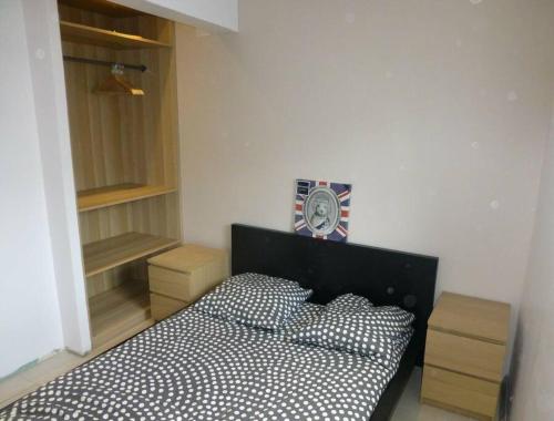 a bedroom with a bed and a clock on the wall at LA PETITE RUELLE in Sainte-Anne