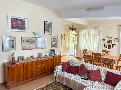 a living room with a couch and a dining room at Bella Vista Holiday Home in Triolet