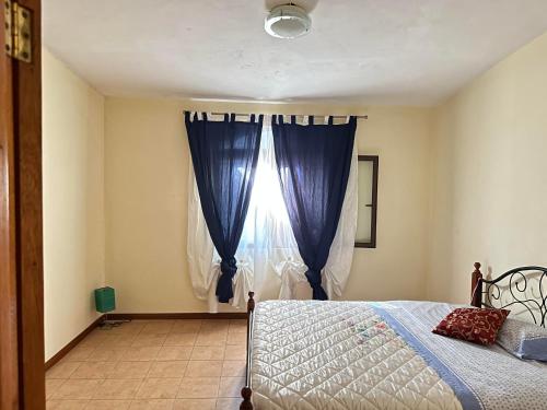 a bedroom with a bed and a window at Bella Vista Holiday Home in Triolet