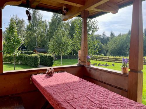 a bed in a room with a large window at Pod Gwiazdami in Dąbrówka