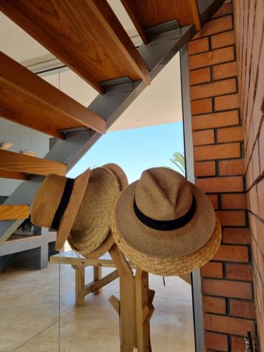 a pair of straw hats sitting on a table in a room at Henties Bay Haven Holiday Home in Hentiesbaai
