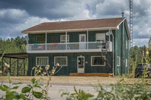 サン・タレクシ・デ・モンにあるLe Refuge du Repaireのバルコニー付きの緑の家