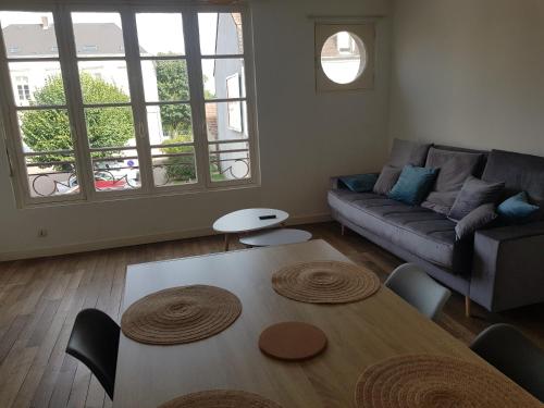 a living room with a couch and a table at Appartement centre d Arcis in Arcis-sur-Aube