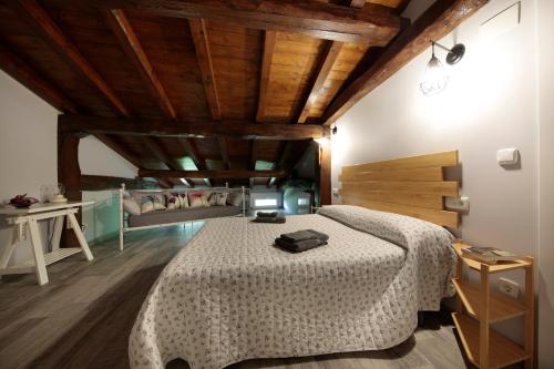 a bedroom with a bed in a room with wooden ceilings at Ondarbaso Apartamentos Rurales III in Zestoa