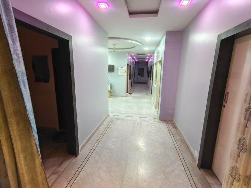 a corridor with purple lights on the ceiling at HOTEL ANJALI in Ujjain
