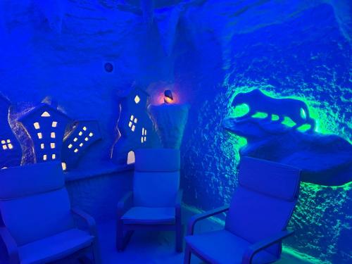 a room with an aquarium with chairs and a candle at PerfectHotel in Myrhorod
