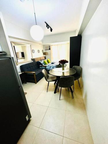 a living room with a table and chairs and a couch at Avida Towers Riala, Tower 2 in Cebu City