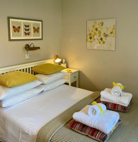 two beds in a room with towels on them at Ellen House Bed and Breakfast in Matlock