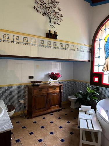 a bathroom with a sink and a toilet and a window at Hotel Rural Convento Santa Maria de la Sierra in Arroyo Frio