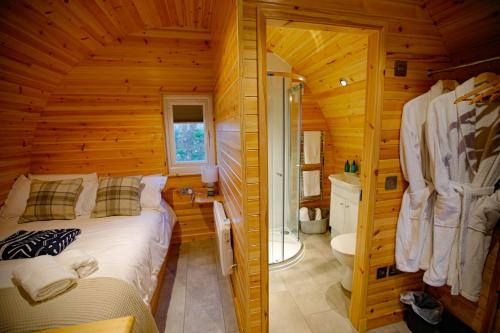 a bedroom with a bed in a log cabin at Berstane Lodges in Orkney