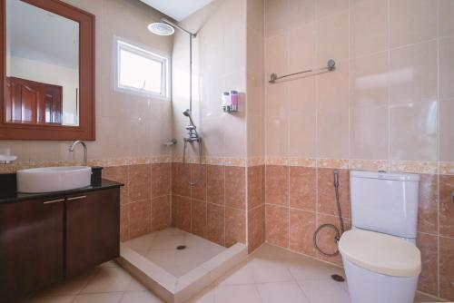a bathroom with a toilet and a sink and a shower at Orchid Pool Villa Phuket - SHA Extra Plus in Phuket Town