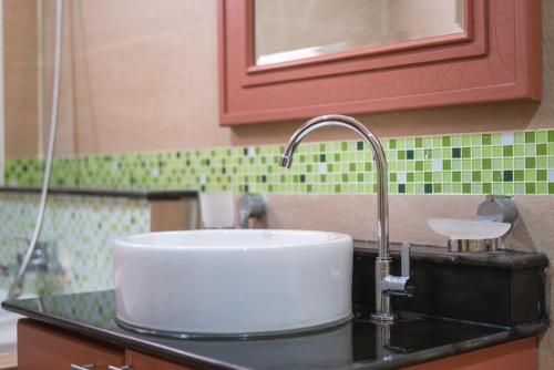 a sink in a kitchen with a red cabinet at Orchid Pool Villa Phuket - SHA Extra Plus in Phuket Town