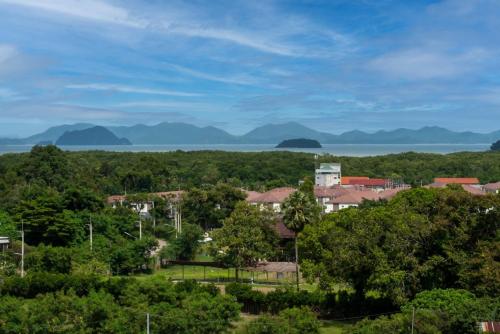 a town with a view of the water and trees at Orchid Pool Villa Phuket - SHA Extra Plus in Phuket Town