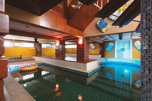 a swimming pool with a donut in the middle of it at Orchid Pool Villa Phuket - SHA Extra Plus in Phuket Town