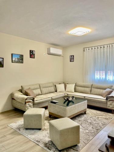 a living room with a couch and a table at Adra's apartment in Shkodër