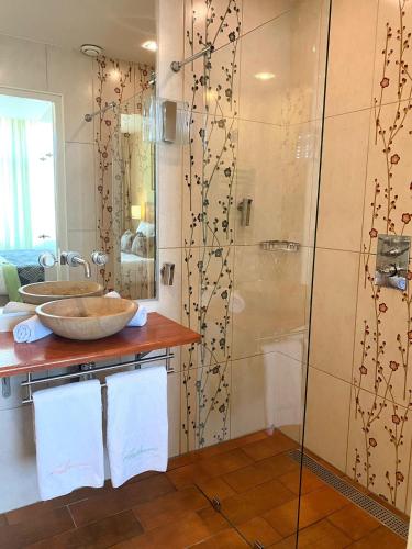 a bathroom with a shower and a sink at Jupiter Hotel in Amsterdam