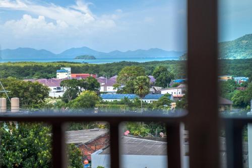 a view of a city from a window at Orchid Pool Villa Phuket - SHA Extra Plus in Phuket Town
