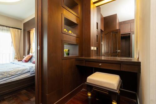 a bedroom with a bed and a desk and a mirror at Orchid Pool Villa Phuket - SHA Extra Plus in Phuket Town