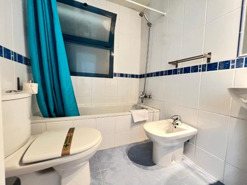 a white bathroom with a toilet and a sink at PUSHE Castell de Ferro Beach & Tradition 2 in Castell de Ferro