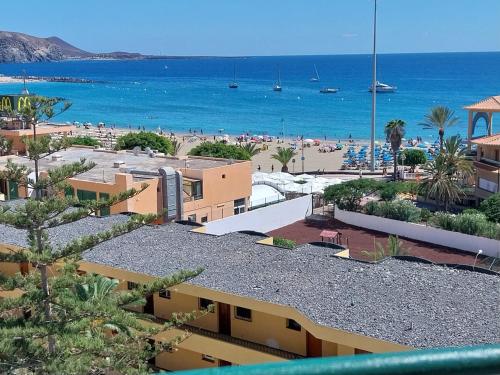 a view of the beach from the balcony of a resort at SOL & MAR Playa de las vistas Torres del Sol A504 in Arona
