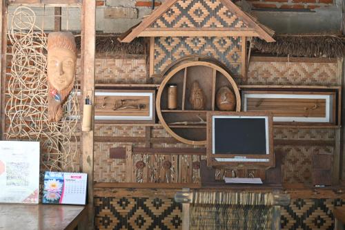 a room with a computer monitor on a wall at Bunga Jabe in Karimunjawa