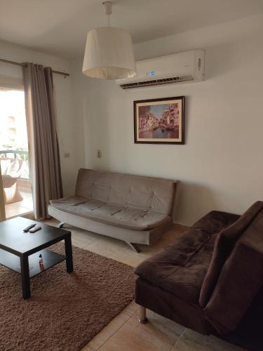 a living room with a couch and a table at Blumar Sidi Abdel Rahman 2 bedrooms Chalet North Coast in El Alamein
