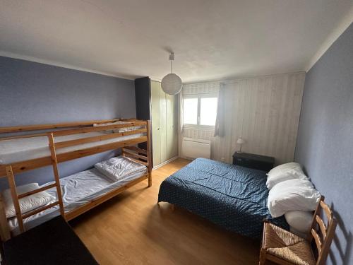 - une chambre avec 2 lits superposés et un lit bleu dans l'établissement font romeu, à Font-Romeu-Odeillo-Via