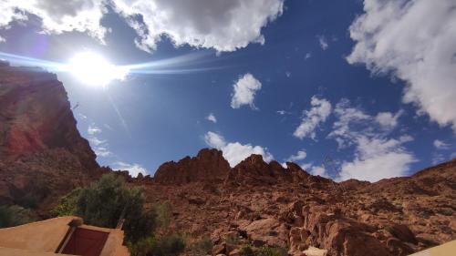 a view of a canyon with the sun in the sky at Hotel AZUL Todra Gorges in Tinerhir