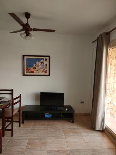 a living room with a ceiling fan and a tv at Blumar Sidi Abdel Rahman 2 bedrooms Chalet North Coast in El Alamein