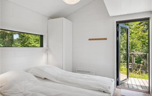 a white bedroom with a bed and a window at 3 Bedroom Amazing Home In Silkeborg in Silkeborg