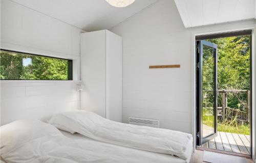 a white bedroom with a bed and a window at Nice Home In Silkeborg With 3 Bedrooms in Silkeborg