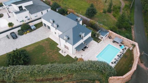 an aerial view of a house with a swimming pool at Villa MY le Mans in Saint-Saturnin