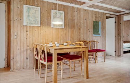 a dining room with a wooden table and chairs at Nice Home In Thyholm With Wifi in Thyholm