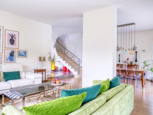 a living room with a couch and a table at Villa MY le Mans in Saint-Saturnin