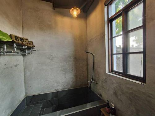 a bathroom with a shower and a window at Soho工房眷村生活體驗館 in Kaohsiung