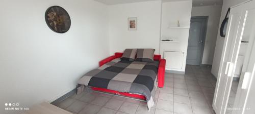 ein Schlafzimmer mit einem Bett in der Ecke eines Zimmers in der Unterkunft Charmant studio au rez de chaussée. in Denain