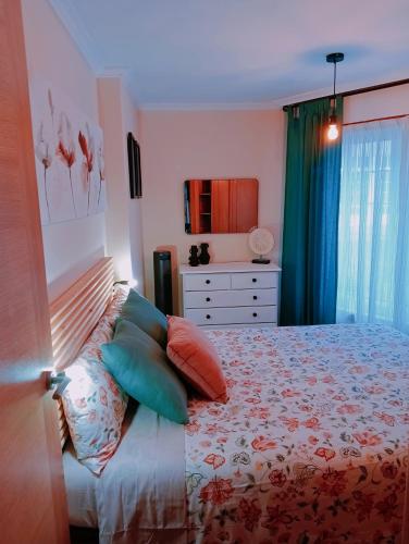 a bedroom with a bed with pillows on it at PAUTANA, céntrico y a pocos minutos de Vigo in Cangas de Morrazo