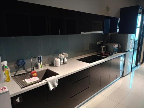 a kitchen with a sink and a counter top at Urbano Luxury Maritime Suite in George Town