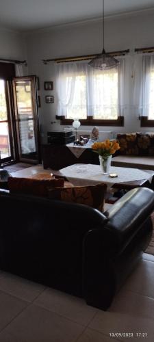 a living room with a couch and a table at Mavridis House in Eleftheroúpolis