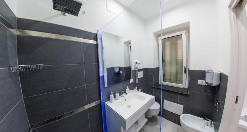 a bathroom with a sink and a toilet and a mirror at B&B Diana in Piazza Armerina