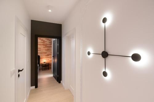 a hallway with a clock on the wall at Harmonia Apartament with Parking in Toruń
