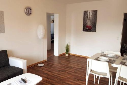 a living room with a table and a couch at Work & Stay 3 Room Apartment in Plettenberg