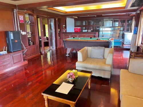 a living room with a pool table and a couch at Orchid Pool Villa Phuket - SHA Extra Plus in Phuket Town