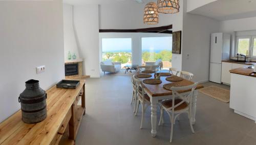 a kitchen and dining room with a table and chairs at Casa Avellana 37 in Denia