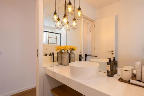 a bathroom with two sinks and a large mirror at MHouse lease Cascais Av 25 Abril in Cascais