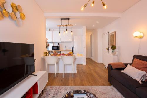 a living room with a couch and a kitchen at MHouse lease Cascais Walk to Beach and center in Cascais