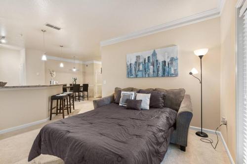 a living room with a large bed and a kitchen at Lovely 1-bedroom apartment w/ Pool + Wi-Fi in Charlotte
